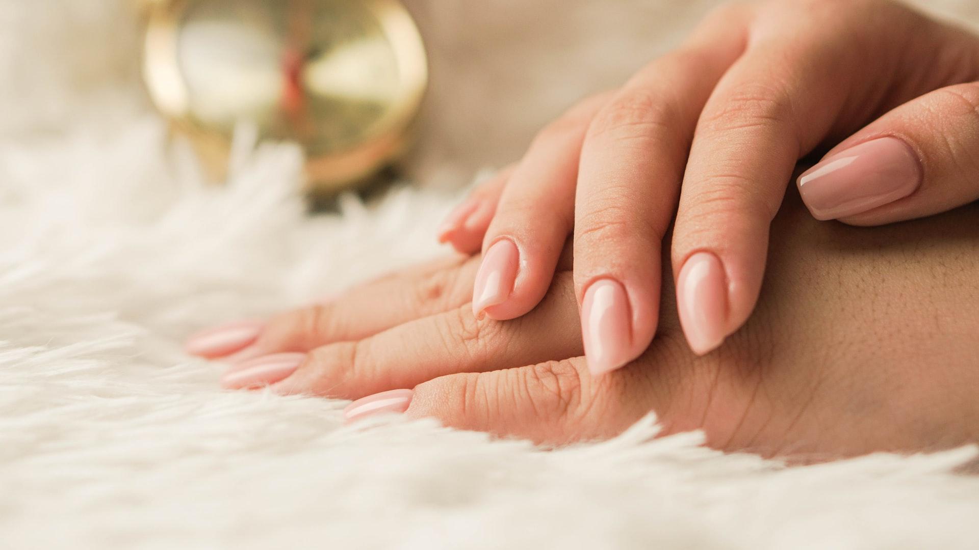 persons hand on white textile